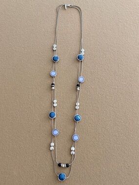 Long silver necklace with blue circles